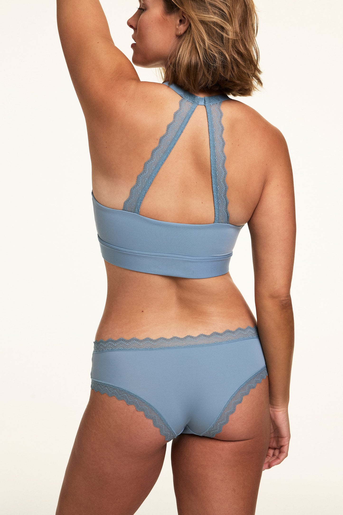 Back view of Sonnie wearing the Bliss Lace Cheeky in Poolside with a matching Poolside bralette, showing the lace racerback detail and cheeky back coverage.