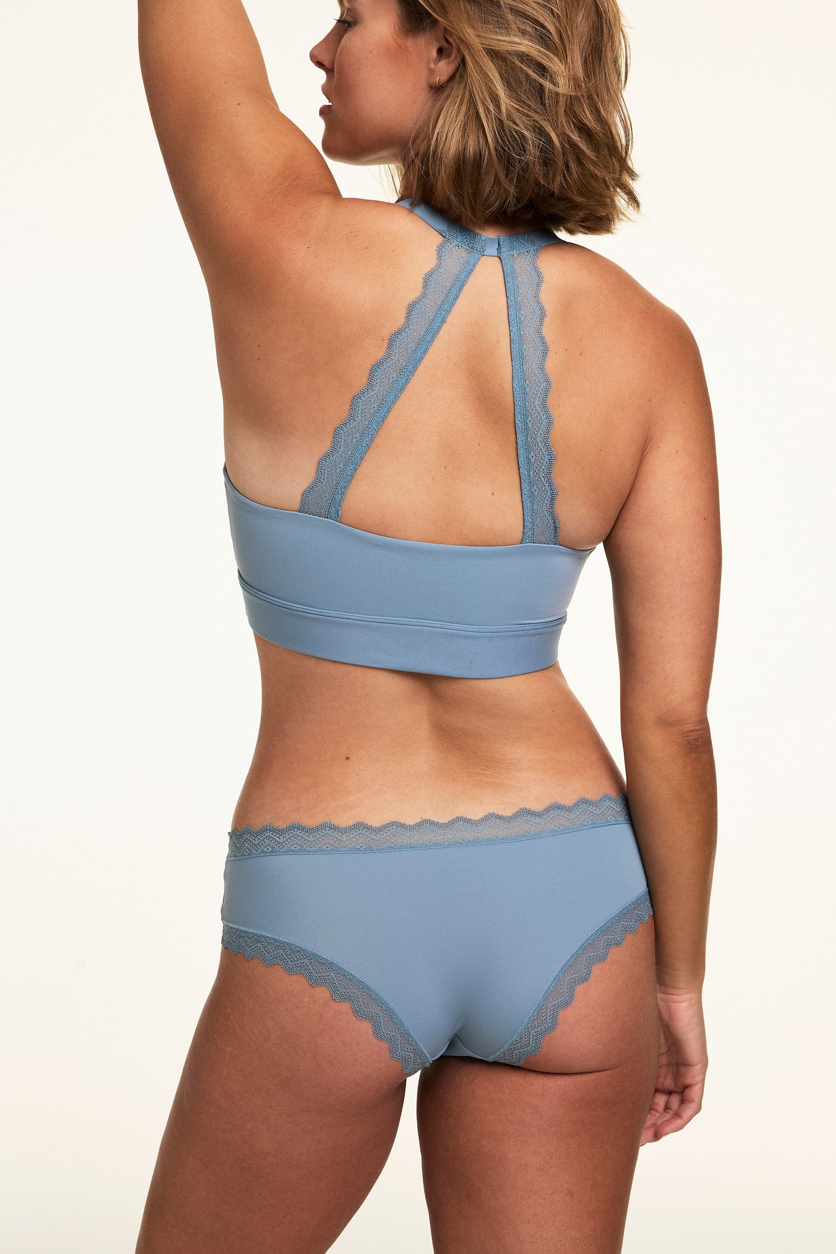 Back view of Sonnie wearing the Bliss Lace Cheeky in Poolside with a matching Poolside bralette, showing the lace racerback detail and cheeky back coverage.