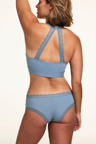 Back view of Sonnie wearing the Bliss Lace Cheeky in Poolside with a matching Poolside bralette, showing the lace racerback detail and cheeky back coverage.