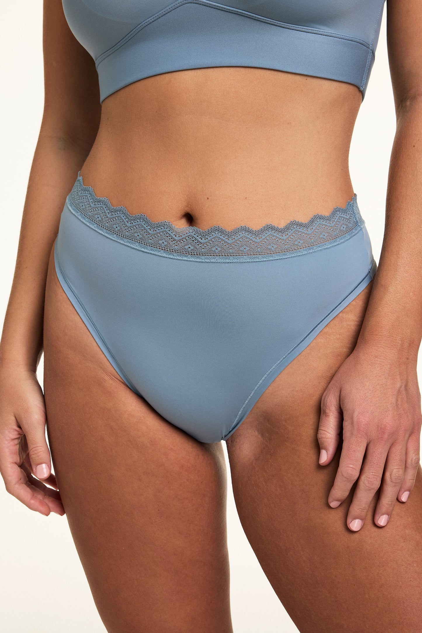Close-up front view of the Bliss Lace Highwaist Thong in Poolside, highlighting the smooth microfiber fabric and scalloped lace waistband.