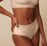 Close-up view of the Bliss Lace Highwaist Brief in Beige on Ally. The image focuses on the intricate lace trim and the smooth, comfortable waistband of the highwaist brief. sizing: Ally wears size Small