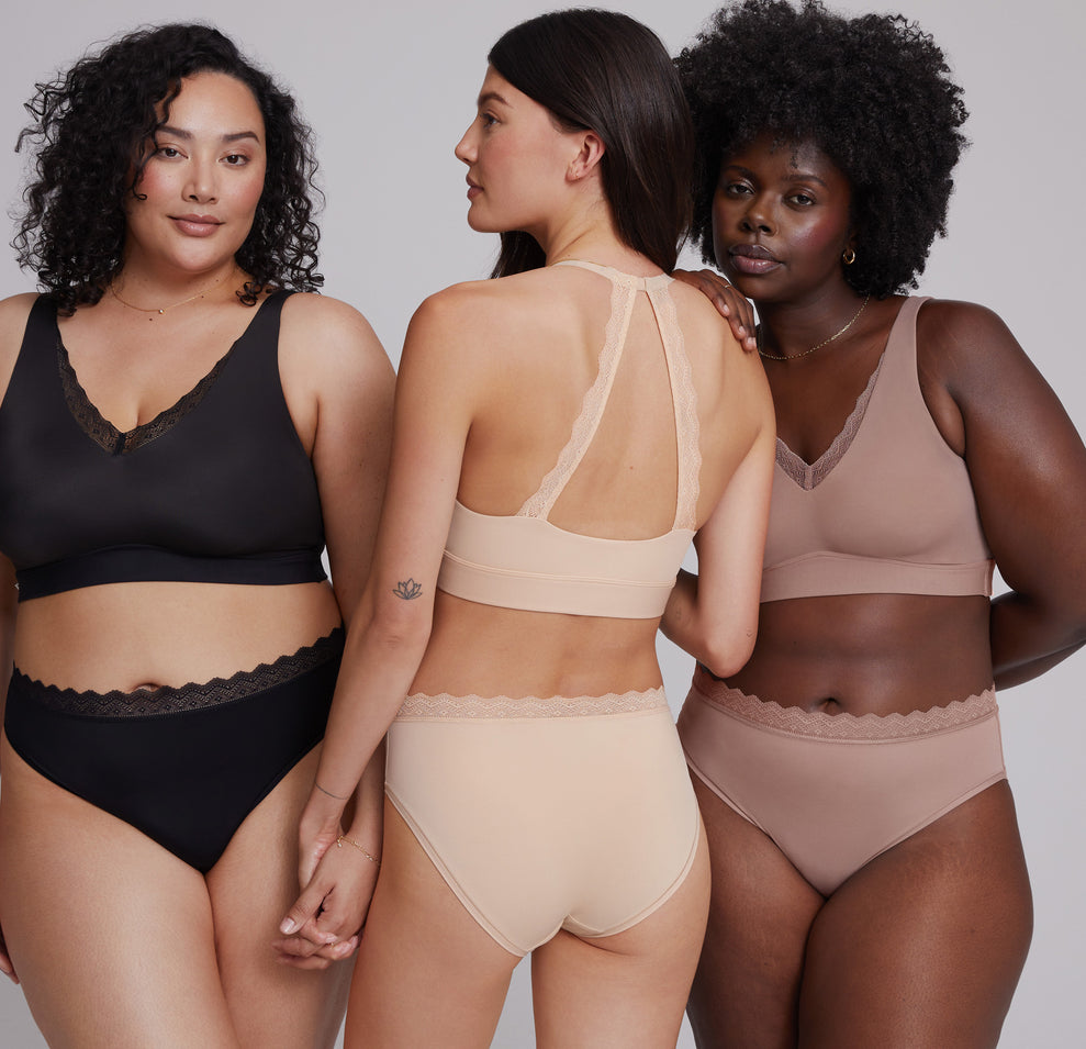From left to right: Bianca wearing the Bliss Lace Bralette and Bliss Lace Highwaist Brief in Black, the second model displaying the back view of the Bliss Lace Halterneck Bralette and Bliss Lace Highwaist Brief in Beige, and the third model wearing the Bliss Lace Bralette and Bliss Lace Highwaist Brief in Mauve. The image highlights the lace detailing on the bralettes and briefs, as well as the comfortable, supportive fit of each piece.
