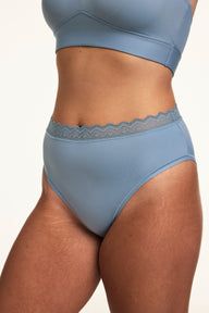 Three-quarter view of the Bliss Lace Highwaist in Poolside, showing the smooth high-rise silhouette and lace waistband detail.