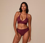 Victoria models the Bliss Lace Highwaist Thong and matching Bliss Lace Halterneck Bralette in Bordeaux. The coordinated set features soft lace trim and Harper Wilde’s signature ultra-soft fabric.