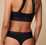 Close-up back view of the Bliss Lace Thong in Black on Anna, highlighting the lace waistband and minimal coverage.