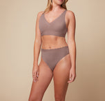 Close-up front view of Megan wearing the Bliss Lace Thong in Mauve, paired with the Bliss Lace Halterneck Bralette. The image emphasizes the thong’s lace trim and smooth fit.