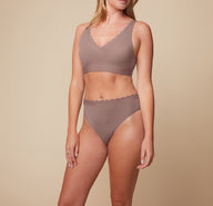 Close-up front view of Megan wearing the Bliss Lace Thong in Mauve, paired with the Bliss Lace Halterneck Bralette. The image emphasizes the thong’s lace trim and smooth fit.