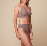 Side view of Megan wearing the Bliss Lace Thong in Mauve, paired with the Bliss Lace Halterneck Bralette. The image highlights the thong’s high-rise design and comfortable fit.