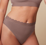 Close-up side view of the Bliss Lace Thong in Mauve on Megan. The image highlights the delicate lace waistband. sizing: Megan wears size Medium