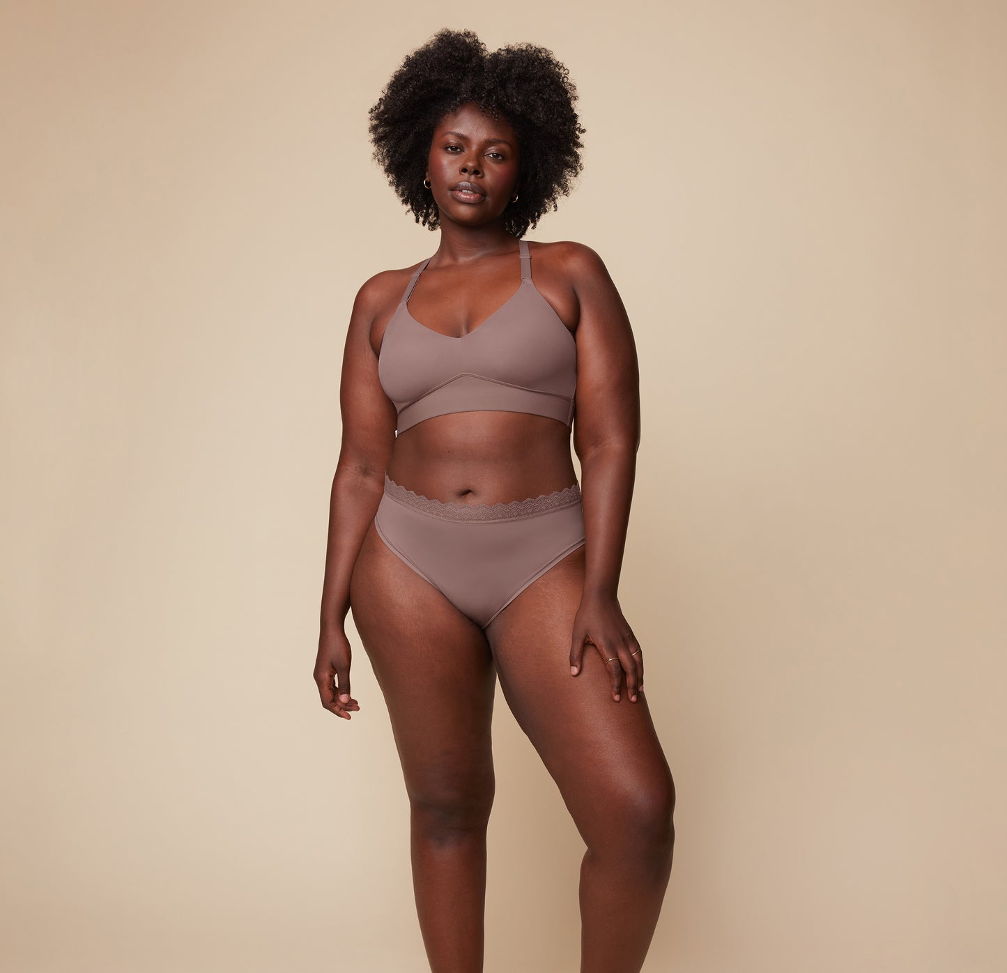 Model Akesha wearing the Bliss Lace Halterneck Bralette in Mauve, paired with the matching Bliss Lace Highwaist Brief in Mauve. She stands facing forward, showcasing the soft, supportive fit of the halterneck bralette and highwaist brief.