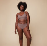 Model Akesha wearing the Bliss Lace Halterneck Bralette in Mauve, paired with the matching Bliss Lace Highwaist Brief in Mauve. She stands facing forward, showcasing the soft, supportive fit of the halterneck bralette and highwaist brief.