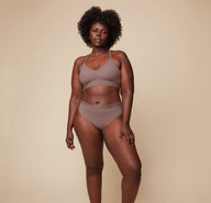 Model Akesha wearing the Bliss Lace Halterneck Bralette in Mauve, paired with the matching Bliss Lace Highwaist Brief in Mauve. She stands facing forward, showcasing the soft, supportive fit of the halterneck bralette and highwaist brief.