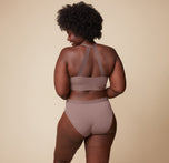 Back view of Akesha wearing the Bliss Lace Halterneck Bralette and matching Bliss Lace Highwaist Brief in Mauve. The image emphasizes the bralette’s lace halterneck strap and the brief’s supportive, high-waist design.