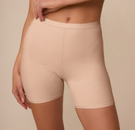 Close-up of the Bliss Under Short waistband on Marcela, emphasizing the soft, flexible fit and minimal seams for comfort under any outfit.