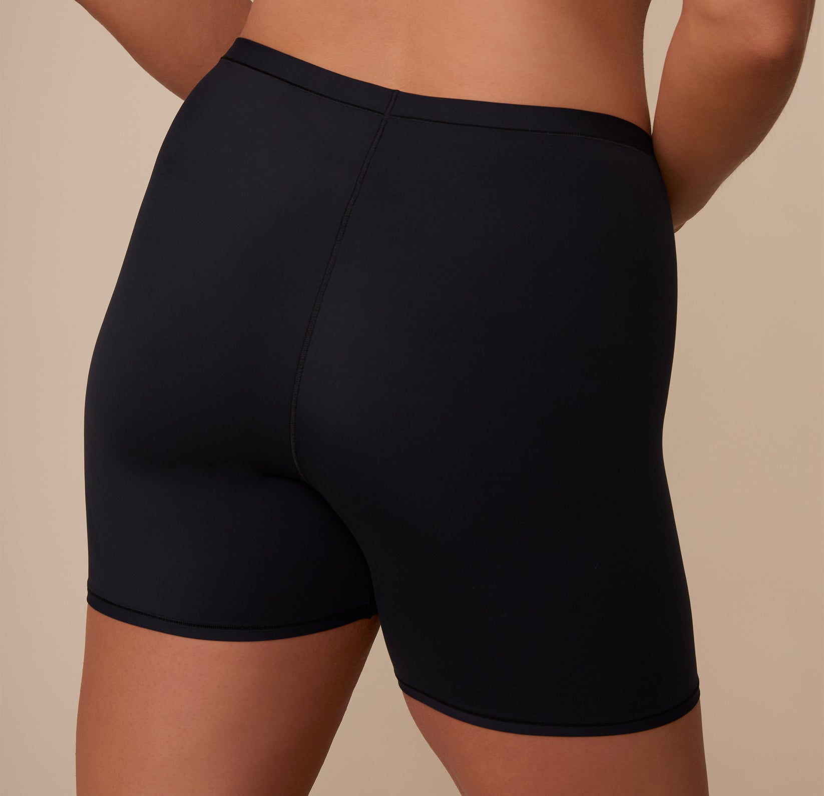 Close-up of the back of the Bliss Under Short on Sonnie, featuring a smooth stretch and coverage designed for layering or lounging.