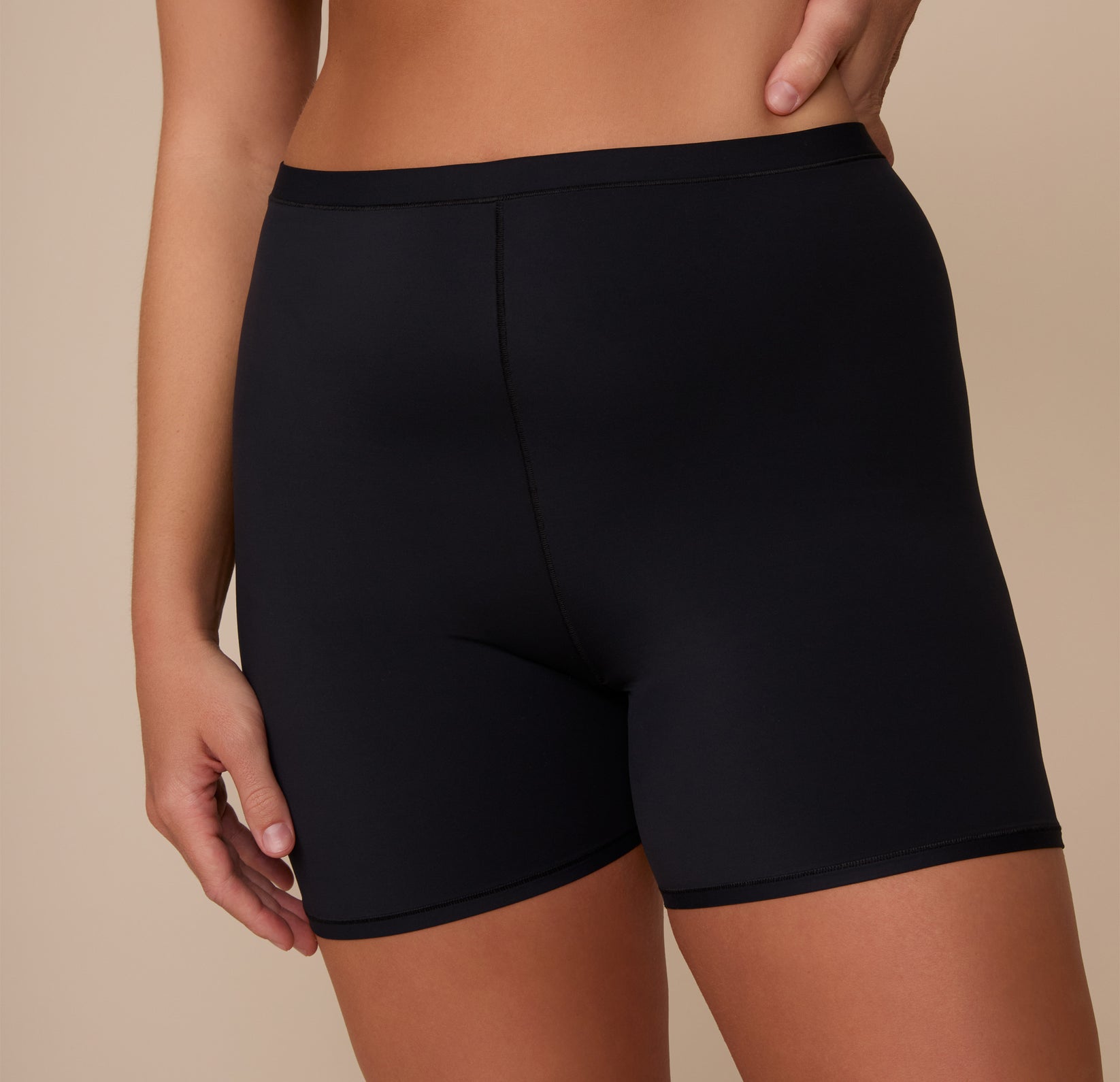 Close-up front detail of the Bliss Under Short in Black, worn by Sonnie, focusing on the soft waistband and second-skin fit ideal for everyday comfort.