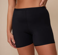 Close-up front detail of the Bliss Under Short in Black, worn by Sonnie, focusing on the soft waistband and second-skin fit ideal for everyday comfort.