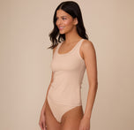 Side view of Marcela wearing the Bliss Tank in Beige. The image shows the relaxed fit through the torso and the clean construction at the neckline and armholes.