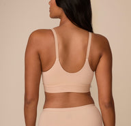 A rear view of Victoria wearing the Bliss Nursing Bralette in Beige, highlighting the scoop back and comfortable straps. The wide underband offers a secure, comfortable fit.