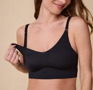 Gracie models the Bliss Nursing Bra in Black, demonstrating the pull-down nursing access with a soft, stretchy cup for easy breastfeeding. sizing: Gracie wears size Small