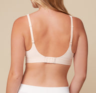 Back view of Megan wearing the Bliss Plunge Adjustable Bralette in Rose, displaying the standard strap configuration.