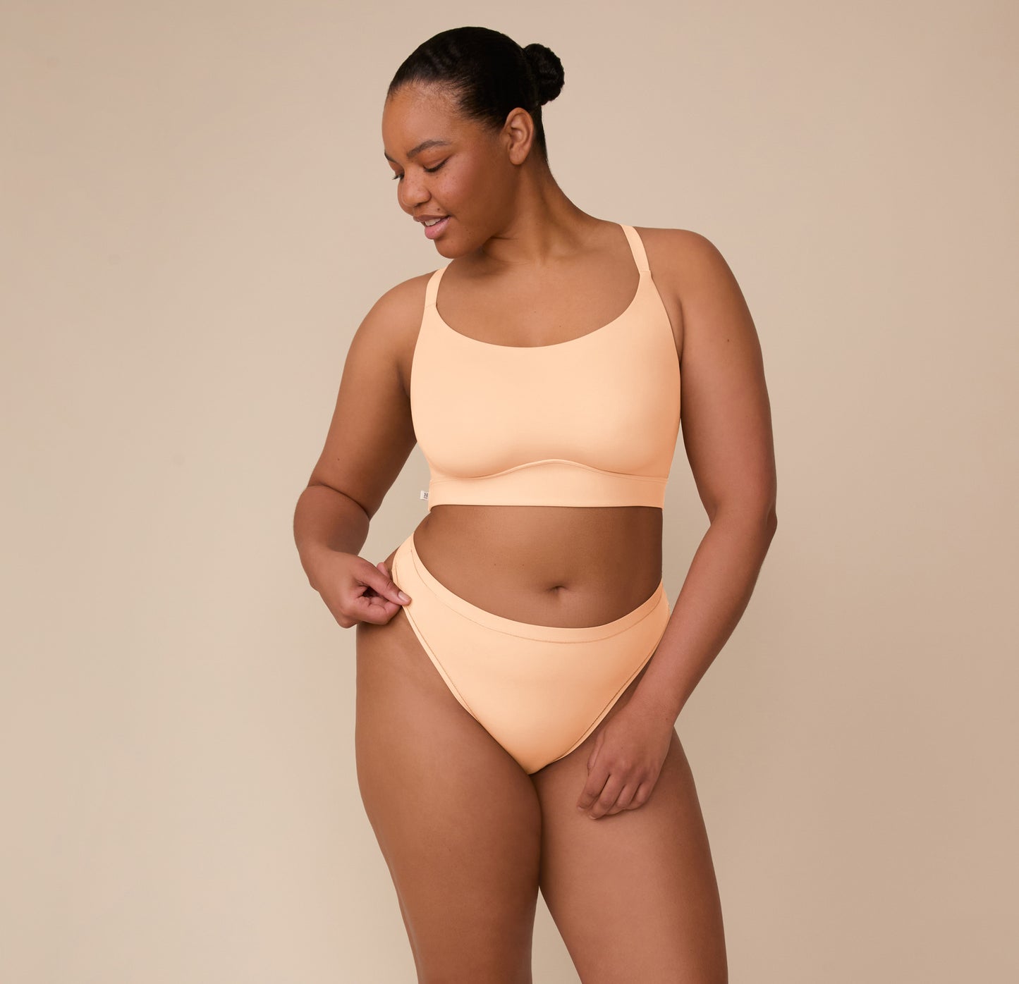 Full front view of Zarria modeling the Bliss Racerback Bralette in Daybreak, with a relaxed pose that shows the ultra-soft fabric and supportive construction.
