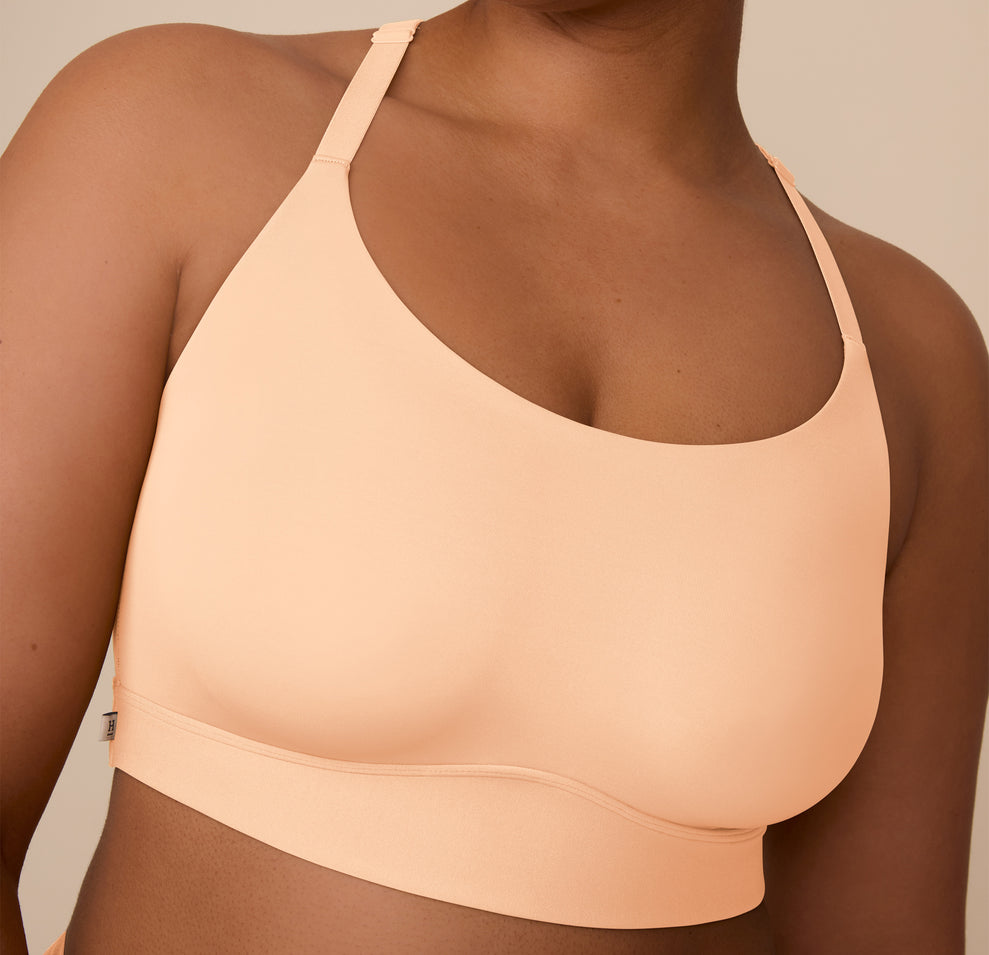 Close-up of Zarria wearing the Bliss Racerback Bralette in Daybreak, focusing on the neckline and buttery-soft finish for everyday comfort.