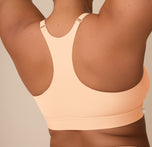 Detail of the racerback style on the Bliss Racerback Bralette in Daybreak, highlighting the adjustable straps, smooth seams and lightweight stretch material.