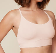 A close-up side view of the Bliss Racerback Bralette in Rose, worn by Carli. The image focuses on the bralette's soft fabric and its comfortable fit.