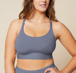 Summerlyn standing with her hand on her hip, wearing the Bliss Racerback Bralette in Steel and the Bliss Boyshort in Steel. The front view highlights the supportive fit of the bralette and the comfortable coverage of the boyshort. sizing: Summerlyn wears size Large