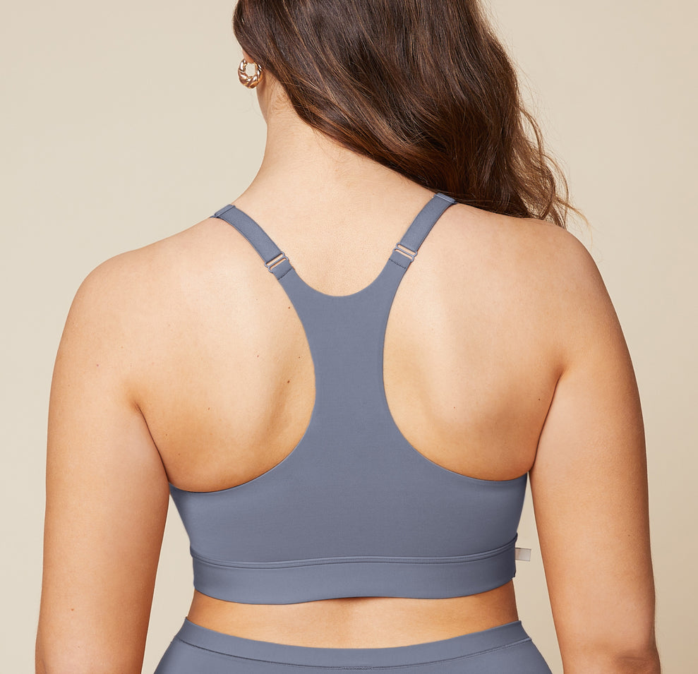 A back view of Summerlyn wearing the Bliss Racerback Bralette in Steel and the Bliss Boyshort in Steel. The image highlights the racerback design of the bralette and the full coverage provided by the boyshort.