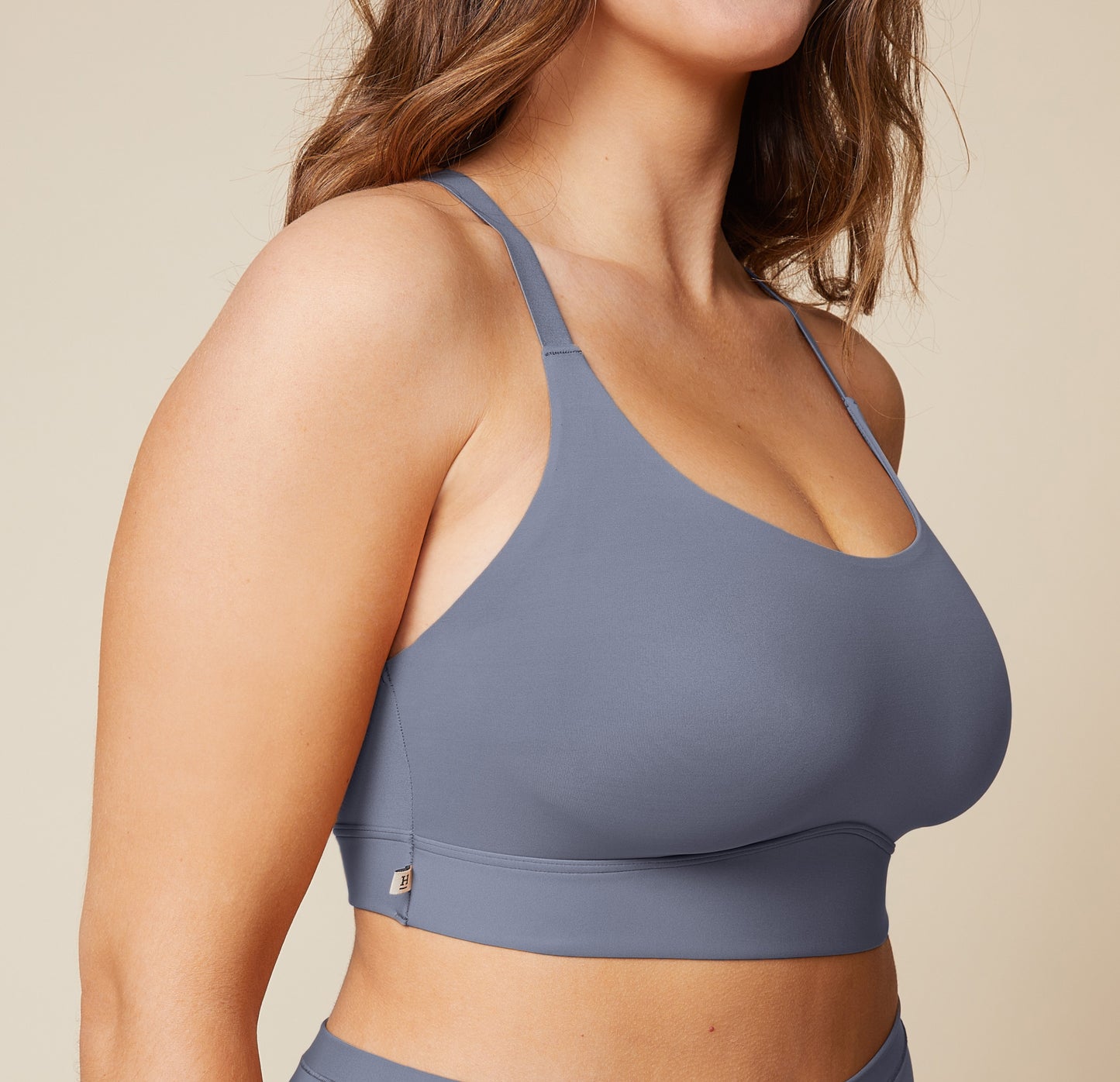 A close-up side view of the Bliss Racerback Bralette in Steel, worn by Summerlyn. The image focuses on the soft fabric and the comfortable fit of the bralette.