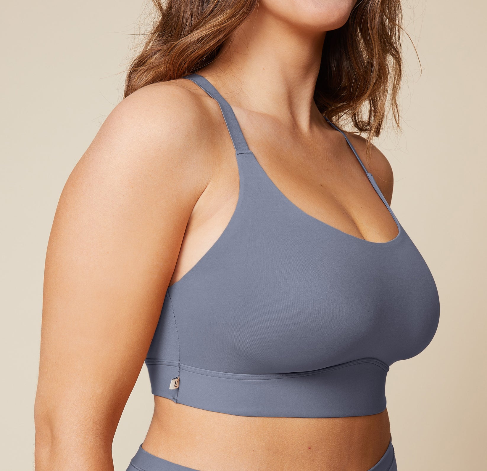 A close-up side view of the Bliss Racerback Bralette in Steel, worn by Summerlyn. The image focuses on the soft fabric and the comfortable fit of the bralette.
