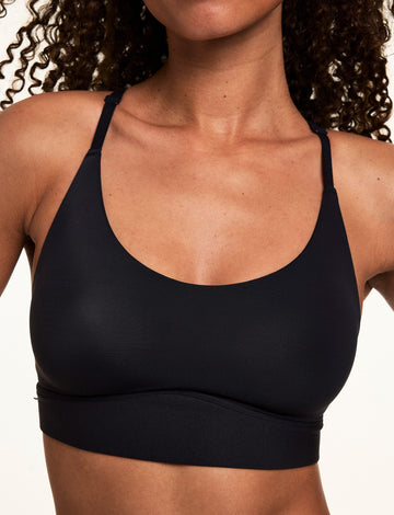 Close-up front view of Courtney wearing the Bliss Racerback Bralette in Black, highlighting the scoop neckline, smooth fabric, and supportive underband.  
