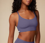 Close-up of Ally wearing the Bliss Racerback Bralette in Overcast. The soft fabric and functional design highlight its everyday wearability.