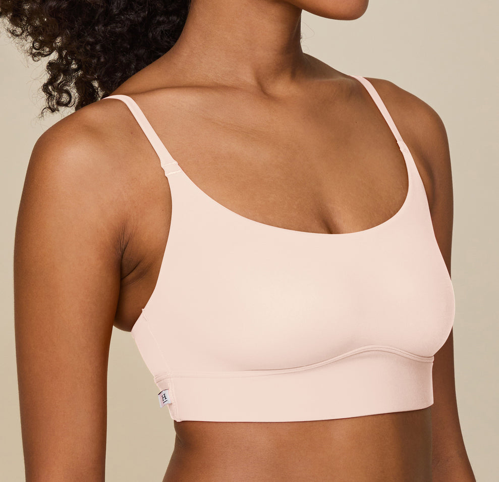 Close-up of Zoe’s upper body in the Bliss Scoop Bralette in Rose, showing the fit of the bralette’s straps and fabric against her skin.