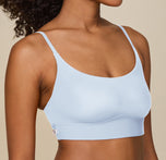 Close-up of Zoe’s upper body in the Bliss Scoop Bralette in Tidal, showing the fit of the bralette’s straps and fabric against her skin.