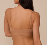 Rear view of Marcela in the Bliss Scoop Bralette in Tan, showing the low back band and thin, adjustable straps against a neutral background.