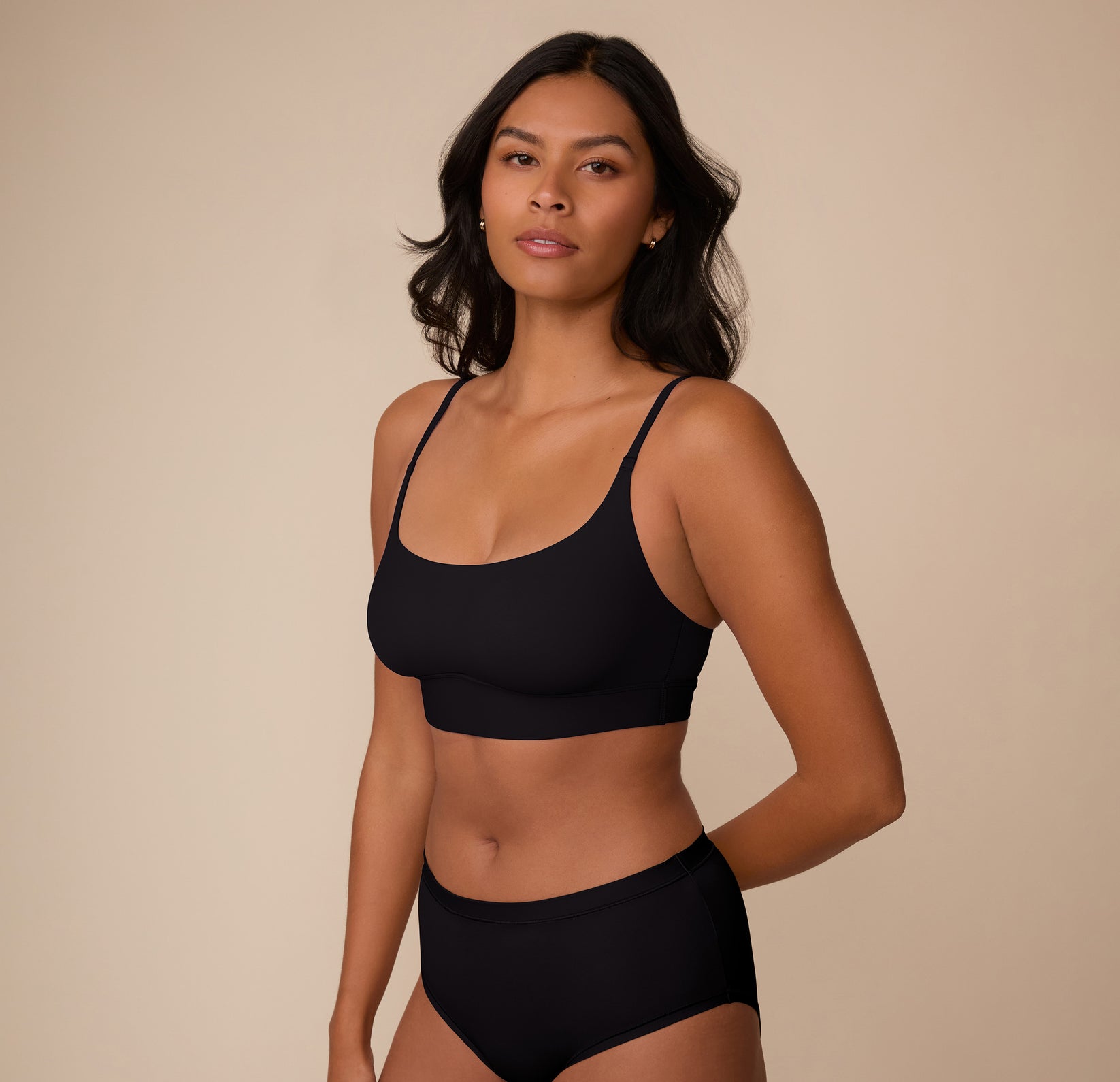 Three-quarter view of Victoria in the Bliss Scoop Bralette and Bliss Highwaist Brief in Black, showcasing the comfortable, everyday fit.