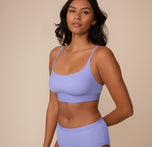 Three quarter front view of Victoria in the Bliss Scoop Bralette in Dusk. The soft stretch fabric contours comfortably to her shape.