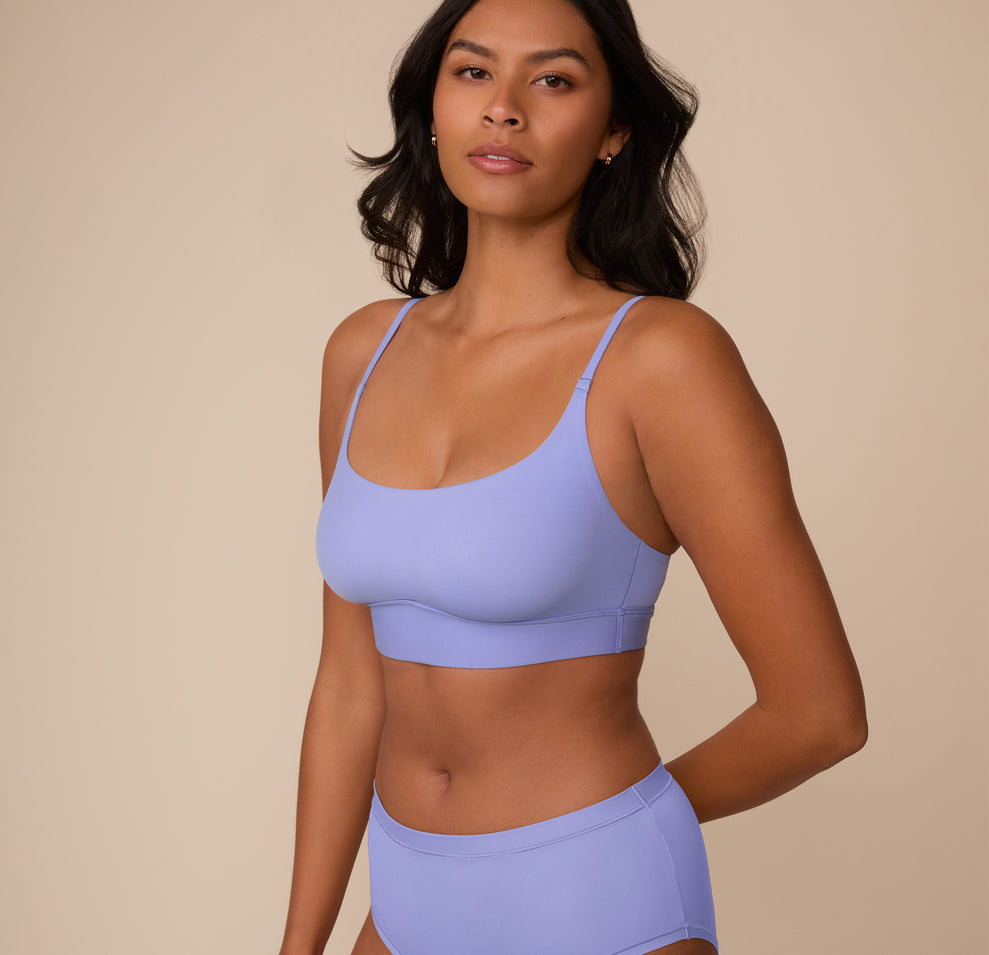 Three quarter front view of Victoria in the Bliss Scoop Bralette in Dusk. The soft stretch fabric contours comfortably to her shape.