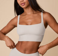 Close-up front view of Ally wearing the Bliss Square Neck Bralette in Frost. The image highlights the bralette’s clean square neckline, wide straps, and supportive band, emphasizing its ultra-soft, wireless construction. sizing: Ally wears size Small