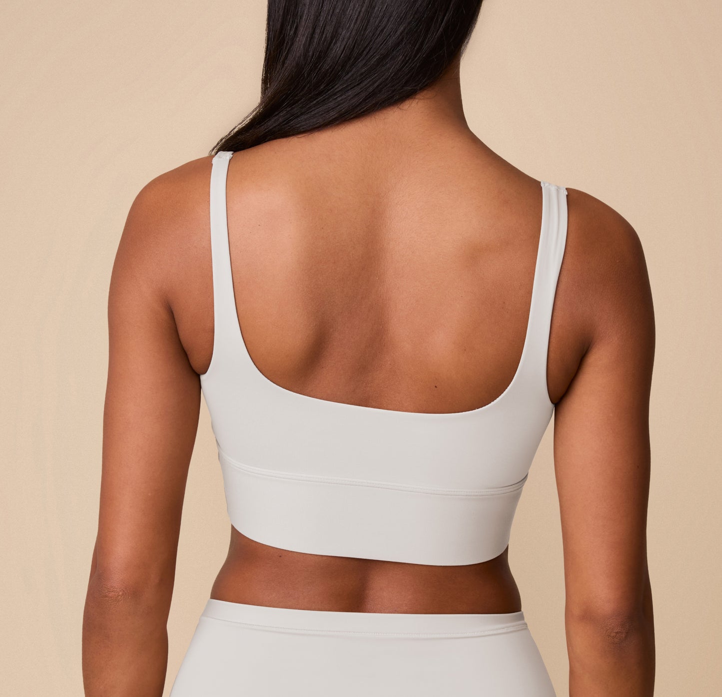 Back view of Ally in the Bliss Square Neck Bralette in Frost. The image shows the scoop-back design and wide band, showcasing the smooth, tagless fit of the bralette.