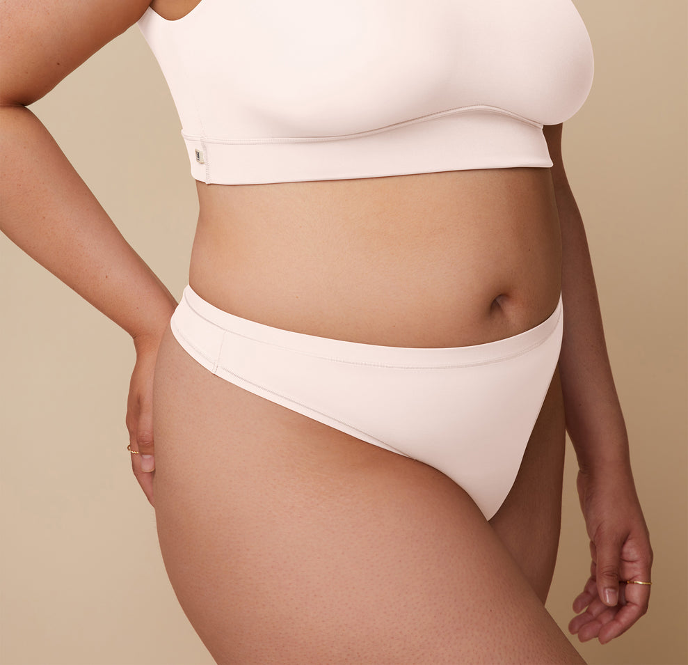 Detailed close-up of Bianca wearing the Bliss Thong in Quartz. The image highlights the thong’s comfortable fit and smooth, soft microfiber fabric, designed for all-day comfort.