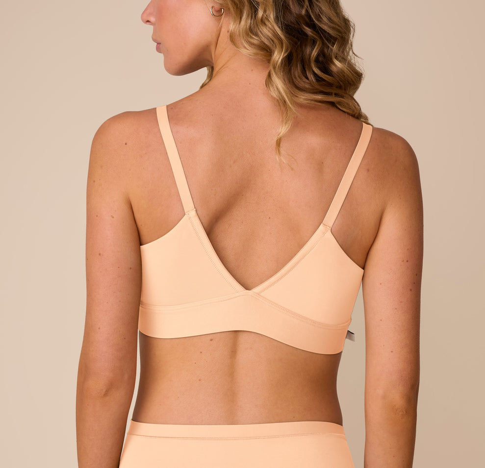 Back view of Freya in the Bliss Triangle Bralette in Daybreak, showcasing the low V back and wide, supportive band.