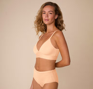 Three quarter view of Freya wearing the Bliss Triangle Bralette and matching Bliss Highwaist Brief in Daybreak, showing the lightweight, second-skin fabric and flattering triangle shape.