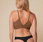 Back view of Megan in the Bliss Triangle Bralette in Brown and Bliss Highwaist Thong in Black. The image highlights the deep V-back of the bralette and the thong’s minimal rear coverage, both designed for smooth lines under clothing.