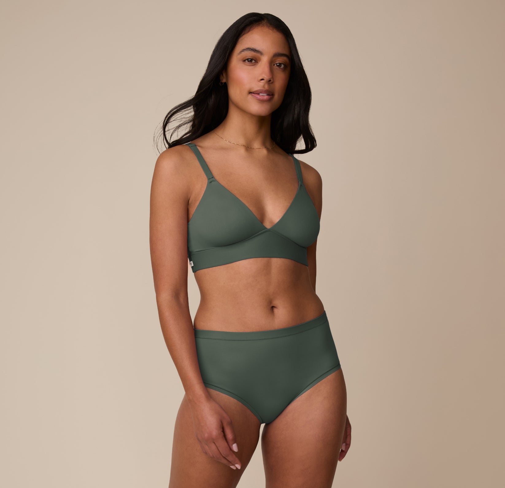 Full-body view of Nemesis in the Bliss Triangle Bralette in Fir, paired with the matching Bliss Highwaist Brief.