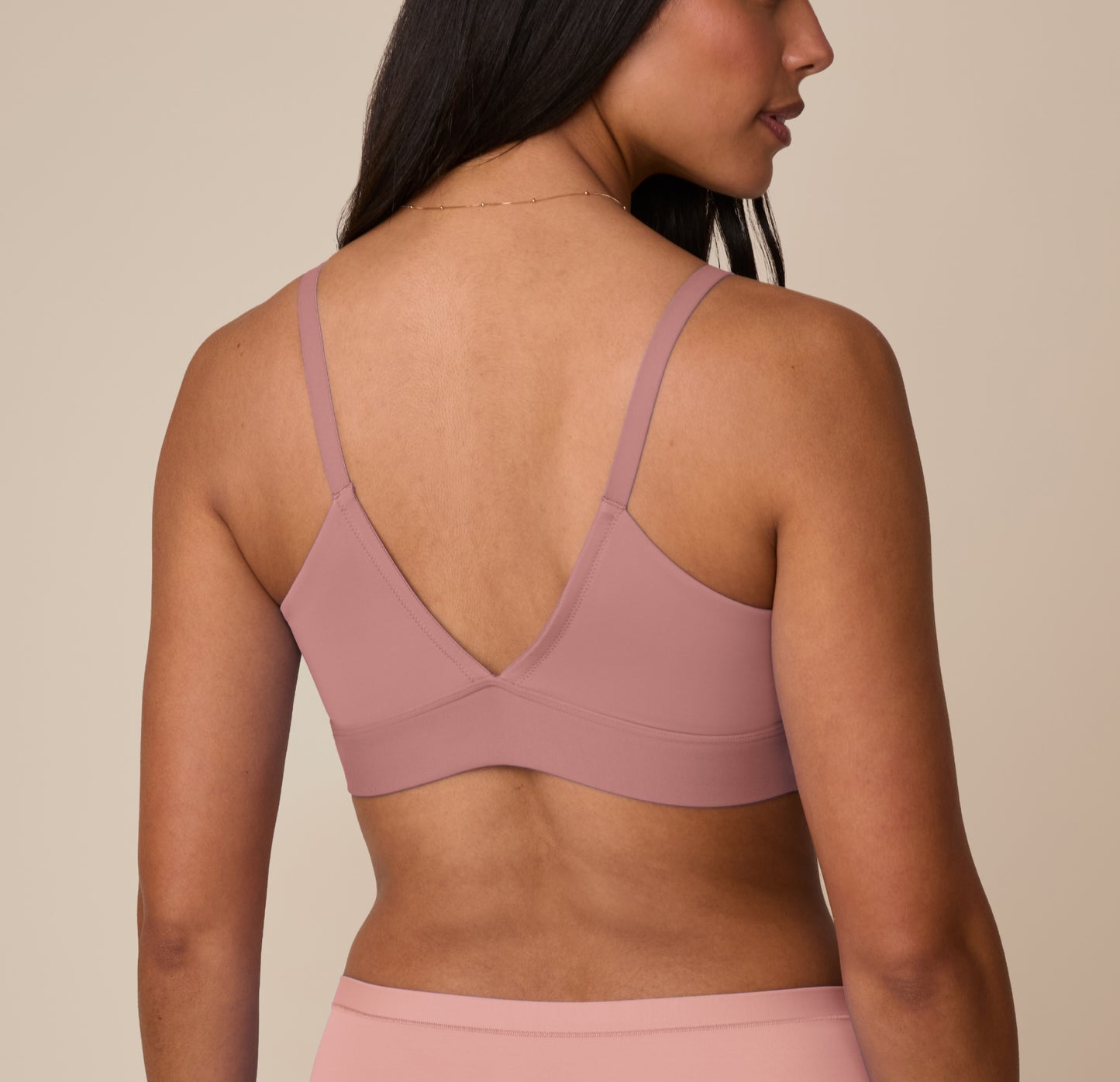 Back view of Marcela in the Bliss Triangle Bralette in Plum, highlighting the V-shaped back, smooth band, and lightweight microfiber design.