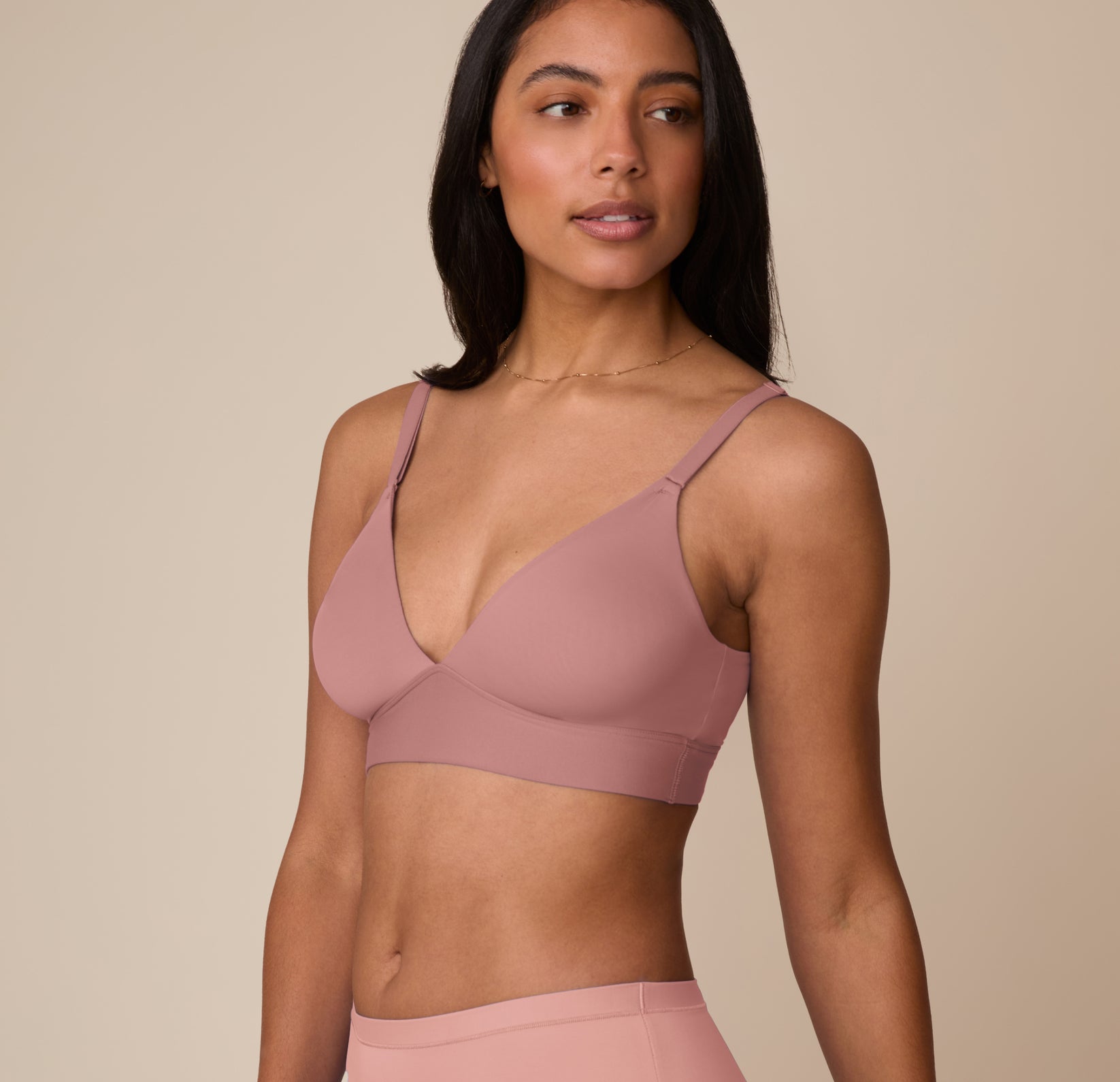 Side angle of Marcela in the Bliss Triangle Bralette in Plum, showing the adjustable straps and soft, flexible cups that provide natural shaping.